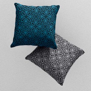 2 cushions with geometric pattern in teal and grey.