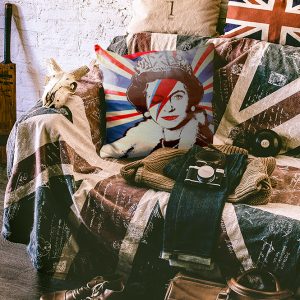 Union jack cushion on chair with face of Queen onunion jack chair with throw.